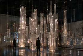 A luminous transparent installation in a dark gallery